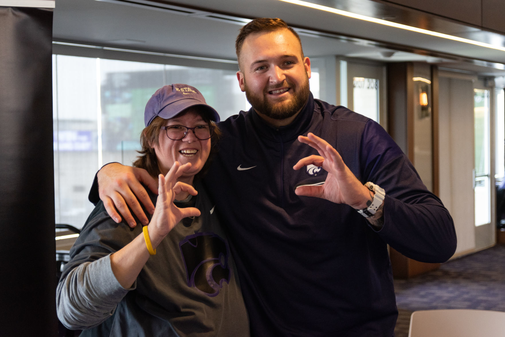 Alesha Channel stands next to Dalton Risner after having him sign her book.